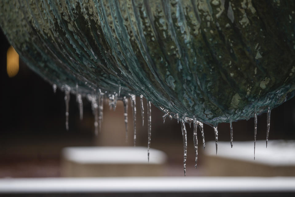 Icicles cling to the Marshall University Memorial Fountain after a winter storm on Monday, Feb. 15, 2021, in downtown Huntington, W.Va. (Ryan Fischer/The Herald-Dispatch via AP)