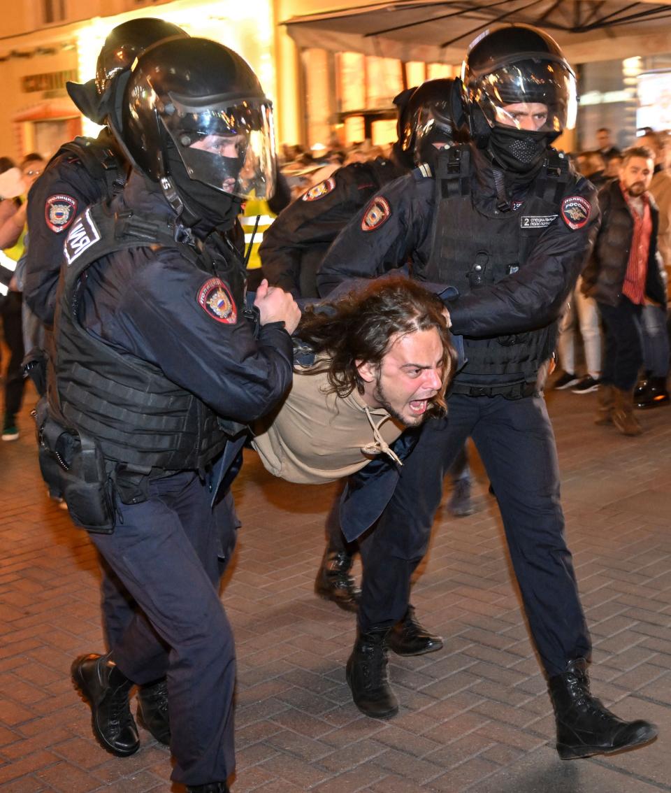 Police officers detain a protestor in Moscow following Putin’s call for partial mobilisation in Russia (AFP via Getty Images)