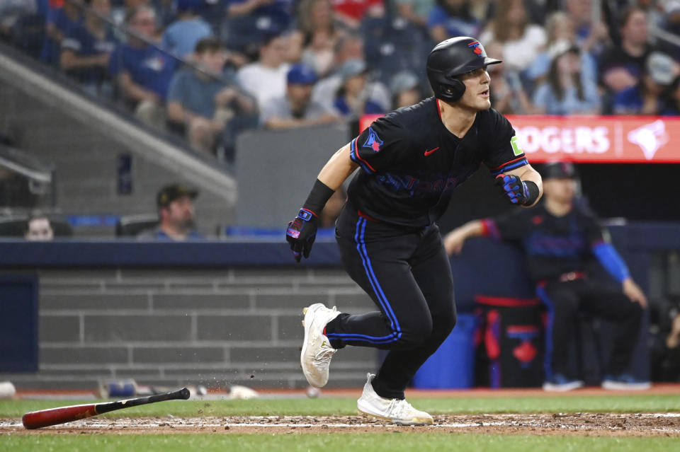 Toronto Blue Jays' Daulton Varsho (25) hits an RBI single against the Houston Astros during the sixth inning of a baseball game in Toronto on Wednesday, July 3, 2024. (Jon Blacker/The Canadian Press via AP)