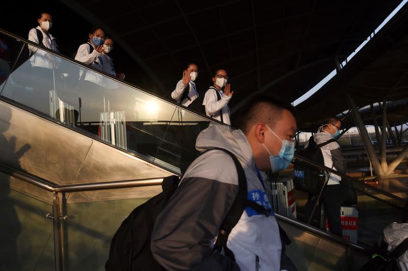 Medical workers from outside Wuhan arrive to a platform at the Wuhan Railway Station before leaving the epicentre of the novel coronavirus disease outbreak