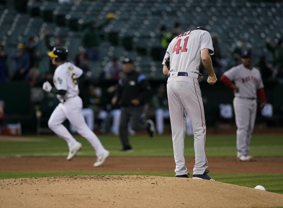 Boston Red Sox pitcher Chris Sale (41) stands on the mound after allowing a solo home run to Oakland Athletics’ Matt Chapman, left, during the first inning of a baseball game in Oakland, Calif., Tuesday, April 2, 2019. (AP Photo/Tony Avelar)