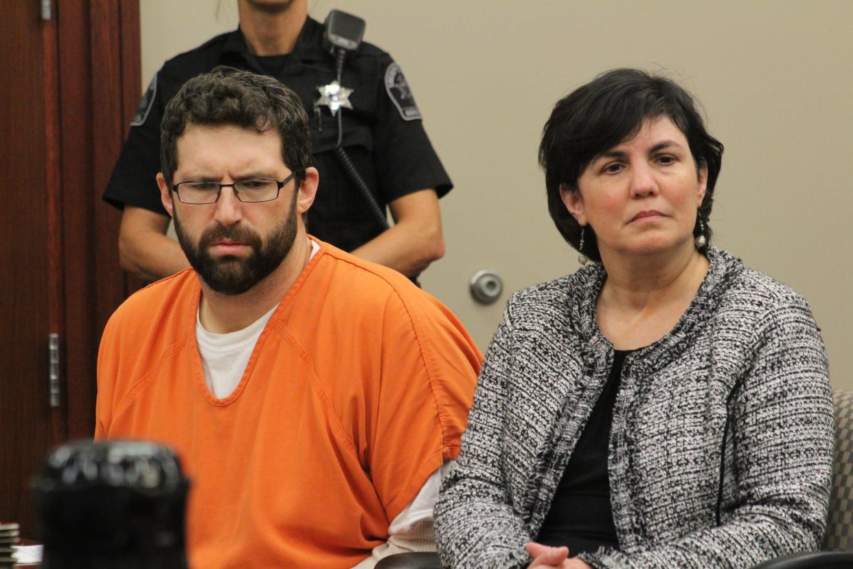 Former Lansing Police Department school resource officer Matthew Priebe listens to victims speak in the courtroom Oct. 2, 2019, at his sentencing hearing for sex assault charges. He was sentenced to one year in jail and five years probation.