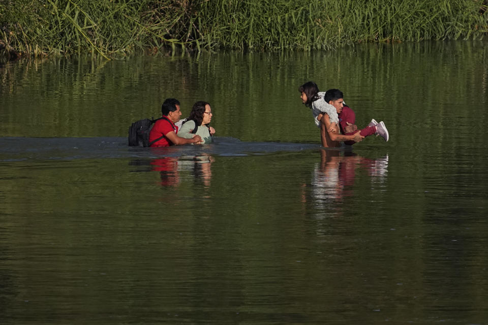 Migrants cross the Rio Grande and entered the U.S. from Mexico, Thursday, Oct. 19, 2023, in Eagle Pass, Texas. Starting in March, Texas will give police even broader power to arrest migrants while also allowing local judges to order them out of the U.S. under a new law signed by Republican Gov. Greg Abbott. (AP Photo/Eric Gay)