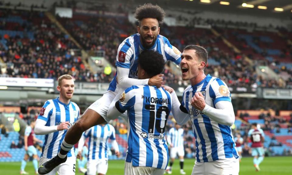 Josh Koroma is congratulated by teammates after scoring Huddersfield’s first goal at Burnley.