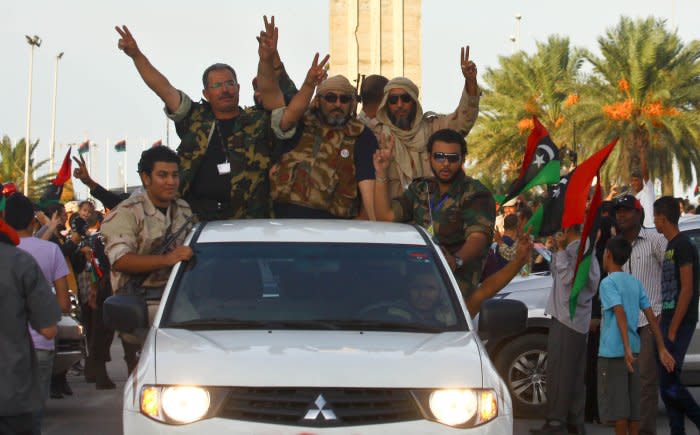 Libyan National Transitional Council fighters celebrate in the streets of Tripoli following news of the fall of Sirte, Libya, the last holdout of Libyan former leader Moammar Gadhafi, who was killed in the attack on October 20, 2011. File Photo by Amru Taha/UPI
