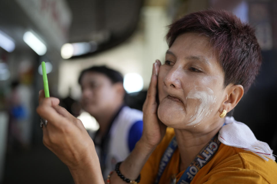 Street sweeper Rose Yatar uses sunblock on her face to protect her from the sun in Manila, Philippines on Monday, April 29, 2024. Millions of students in all public schools across the Philippines were ordered to stay home Monday after authorities cancelled in-person classes for two days as an emergency step due to the scorching heat and a public transport strike. (AP Photo/Aaron Favila)