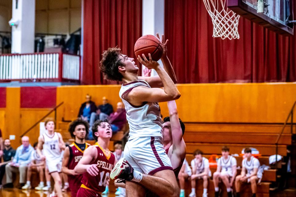 Bishop Stang's Frank Vollaro attacks the basket.