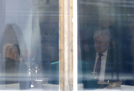 Leader of the Christian Social Union in Bavaria (CSU) Horst Seehofer is seen through the window during the Christian Democratic Union of Germany (CDU) and CSU exploratory talks about forming a new coalition government in Berlin, Germany, October 18, 2017. REUTERS/Hannibal Hanschke