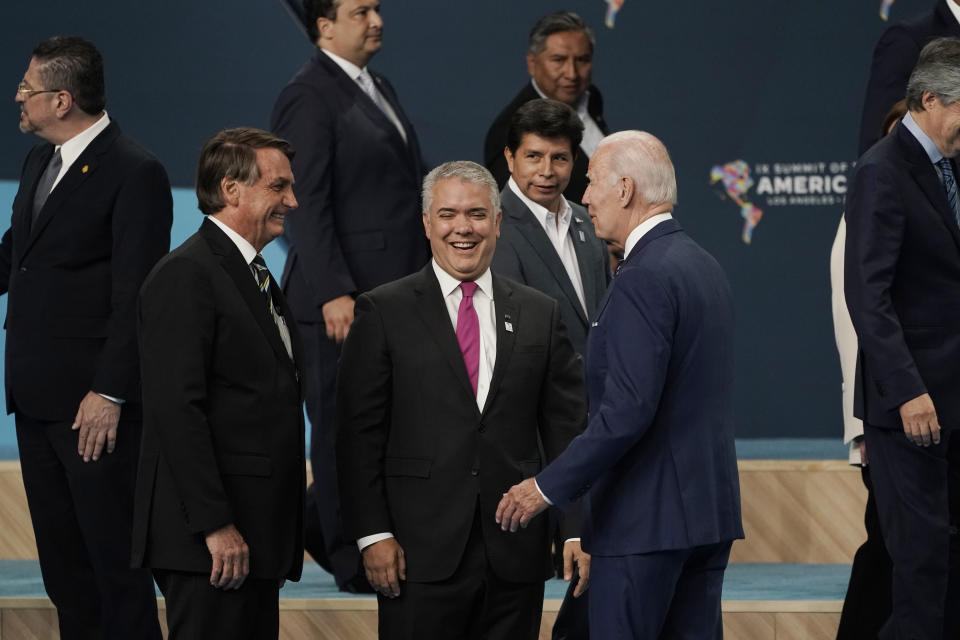 President Joe Biden, right, speaks with Brazilian President Jair Bolsonaro, left, and Colombian President Ivan Duque as they participate in a family photo with heads of delegations at the Summit of the Americas, Friday, June 10, 2022, in Los Angeles. (AP Photo/Jae C. Hong)