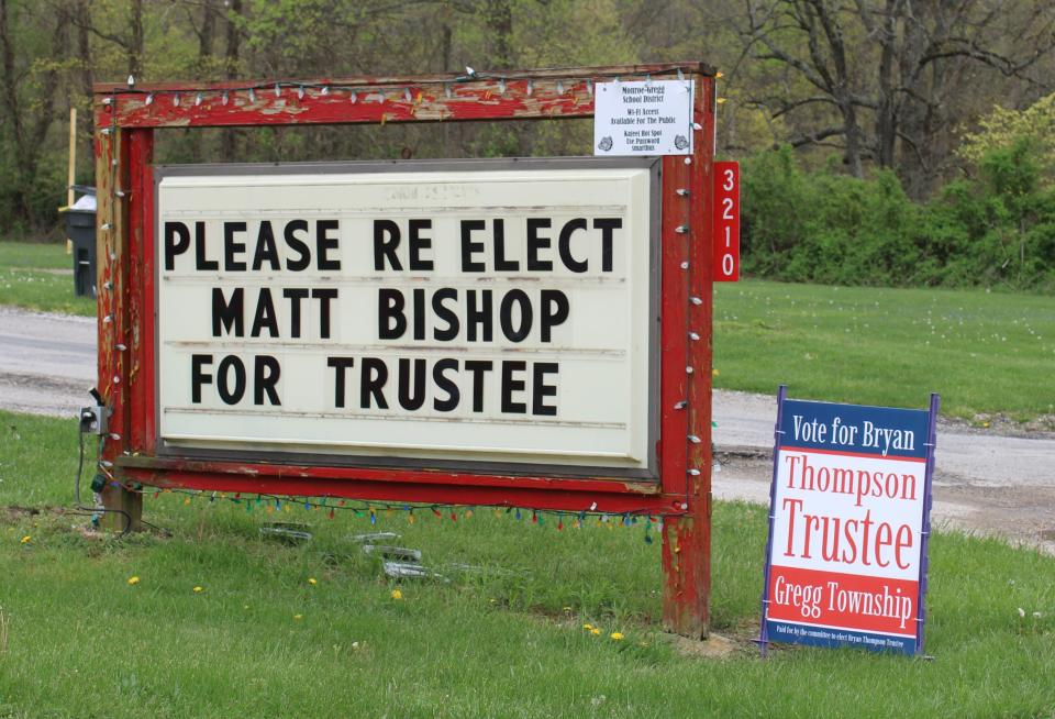 Signs asking for the support of the two Gregg Township Trustee candidates stand at the township's fire station.