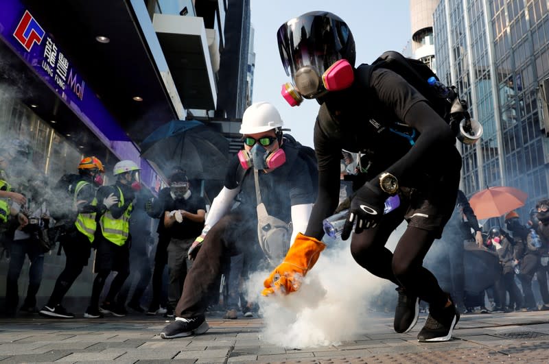 An anti-government protester holds a tear gas canister during a protest in Hong Kong