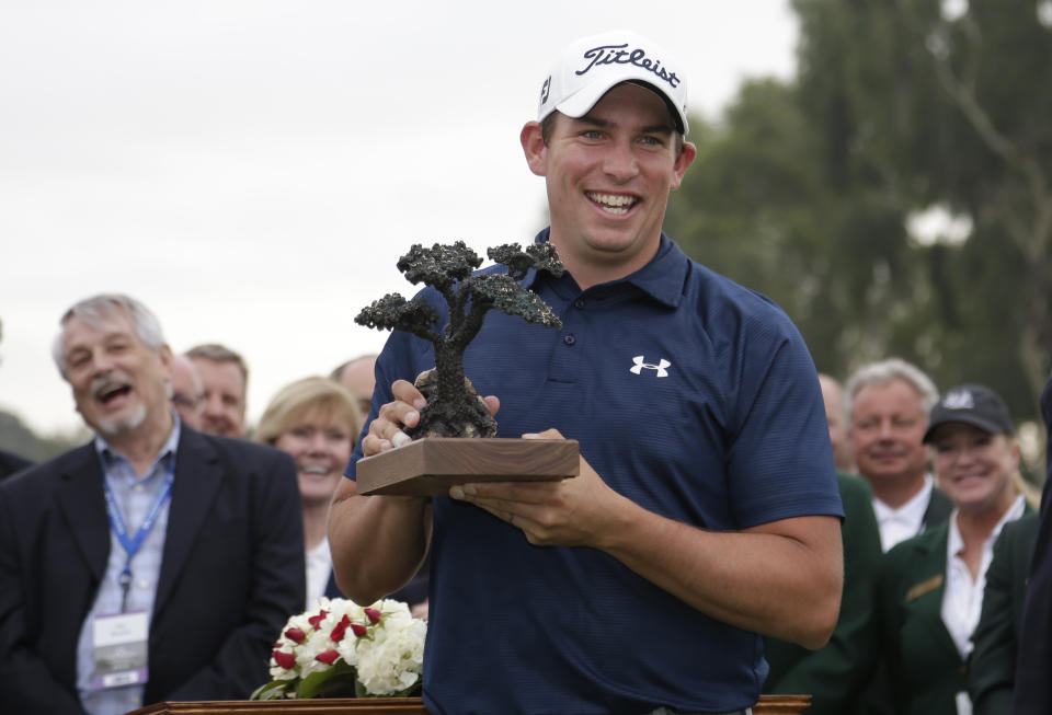 Scott Stallings holds the trophy after winning the Farmers Insurance Open golf tournament Sunday, Jan. 26, 2014, in San Diego. (AP Photo/Gregory Bull)