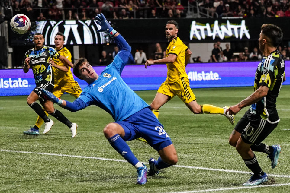 Columbus Crew goalkeeper Patrick Schulte (28) misses the ball as Atlanta United's Thiago Almada (10) scores a goal during the second half of an MLS playoff soccer match, Tuesday, Nov. 7, 2023, in Atlanta. (AP Photo/Mike Stewart)