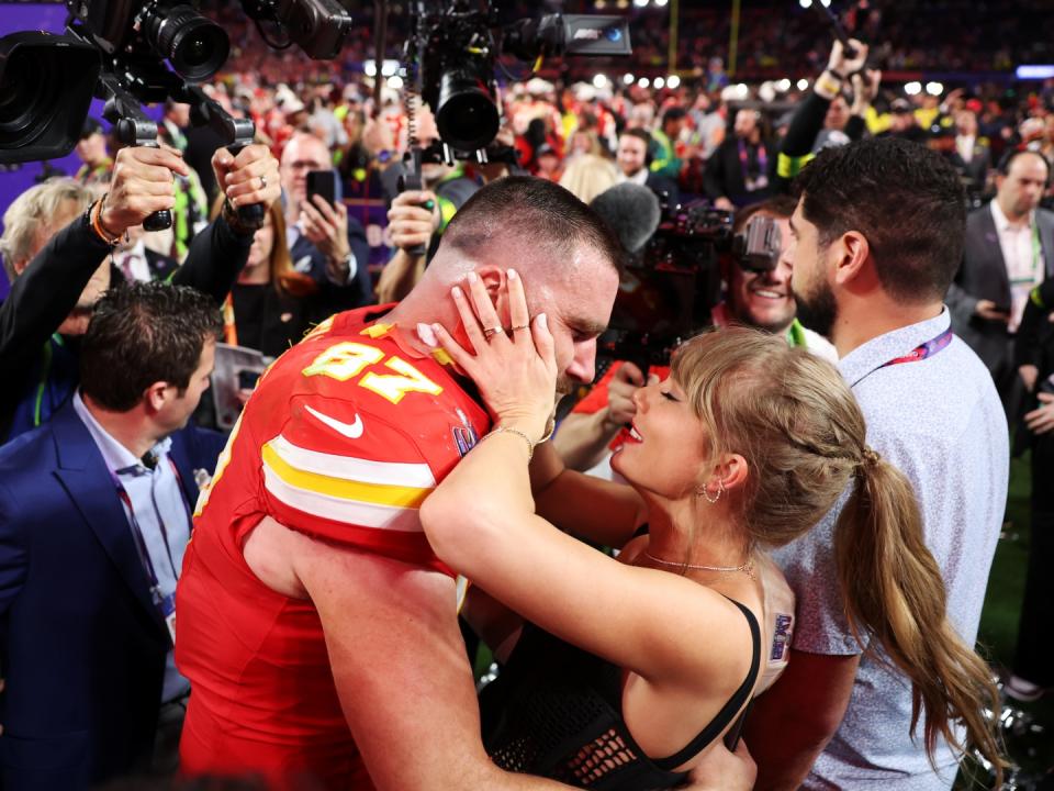 ravis Kelce #87 of the Kansas City Chiefs and Taylor Swift embrace after defeating the San Francisco 49ers in overtime during Super Bowl LVIII at Allegiant Stadium on February 11, 2024 in Las Vegas, Nevada. 