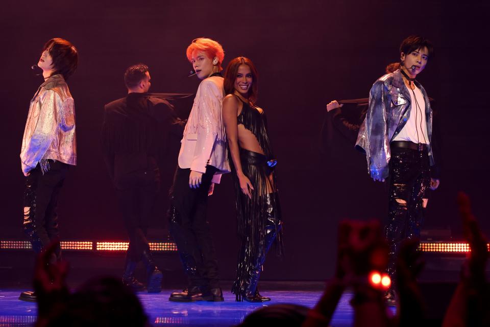 Latin singer Anitta, center right, and Beomgyu, from left, Yeonjun and Taehyun of K-pop group Tomorrow X Together perform at the 2023 MTV Video Music Awards on Sept. 12, 2023. In an increasingly diverse music world, Latin musicians are making a name for themselves thanks to their authentic style.