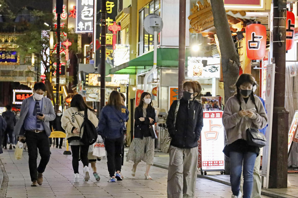 People walk in Chinatown in Yokohama, Kanagawa prefecture, near Tokyo Friday, April 15, 2021. Japan is set to raise the coronavirus alert level in Tokyo’s three neighboring prefectures and a forth area in central Japan to allow tougher measures as a more contagious coronavirus variant spreads and doubts are growing whether the Olympics can go ahead. (Kyodo News via AP)