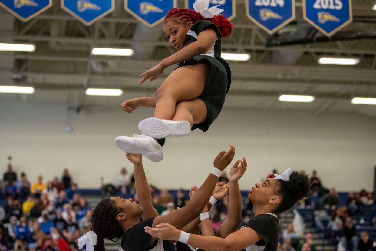 Lakeview varsity cheerleaders lift junior Alaya Marshall during the Mustang Invitational at Portage Central High School on Saturday, Jan. 8, 2022.