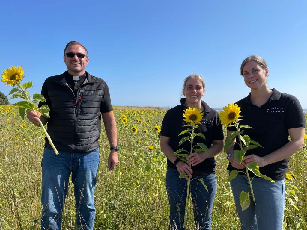 Douglas Creighton with Claire Pollock and her sister Nikki Storrar in the Field of Hope 