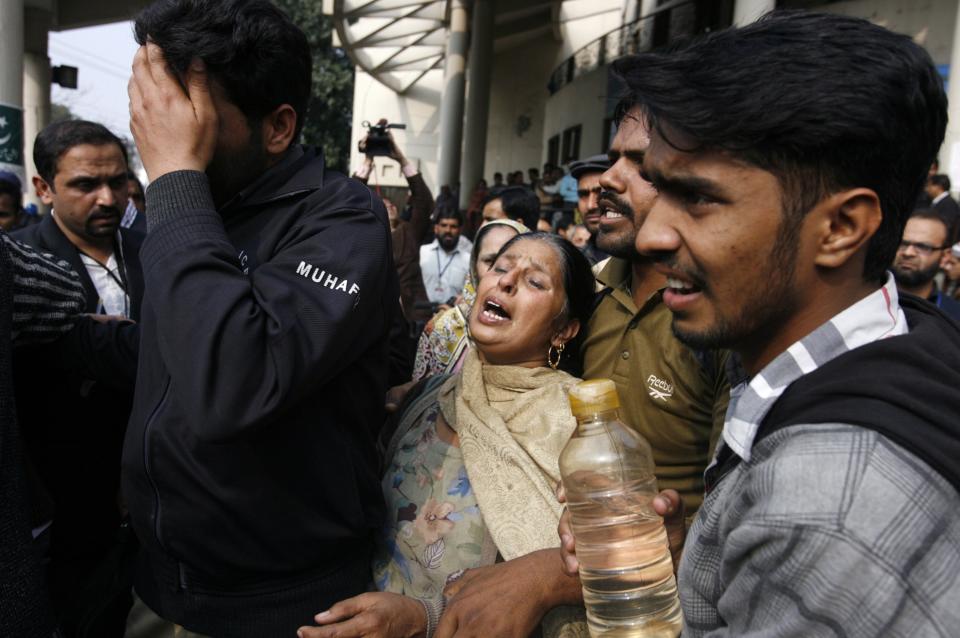 A woman mourns the death of her relative, who was killed in an explosion outside the police headquarters, at a hospital in Lahore