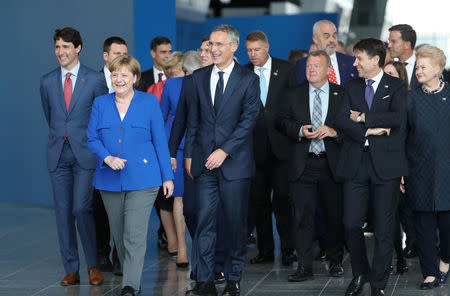 Germany's Chancellor Angela Merkel, Canadian Prime Minister Justin Trudeau, President of Lithuania Dalia Grybauskaite and NATO Secretary-General Jens Stoltenberg are seen at NATO headquarters in Brussels, Belgium, July 11, 2018. Tatyana Zenkovich/Pool via REUTERS