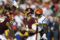 Washington Football Team quarterback Taylor Heinicke (4) looks to pass while under pressure from Cincinnati Bengals defensive end Cameron Sample during the first half of a preseason NFL football game Friday, Aug. 20, 2021, in Landover, Md. (AP Photo/Susan Walsh)