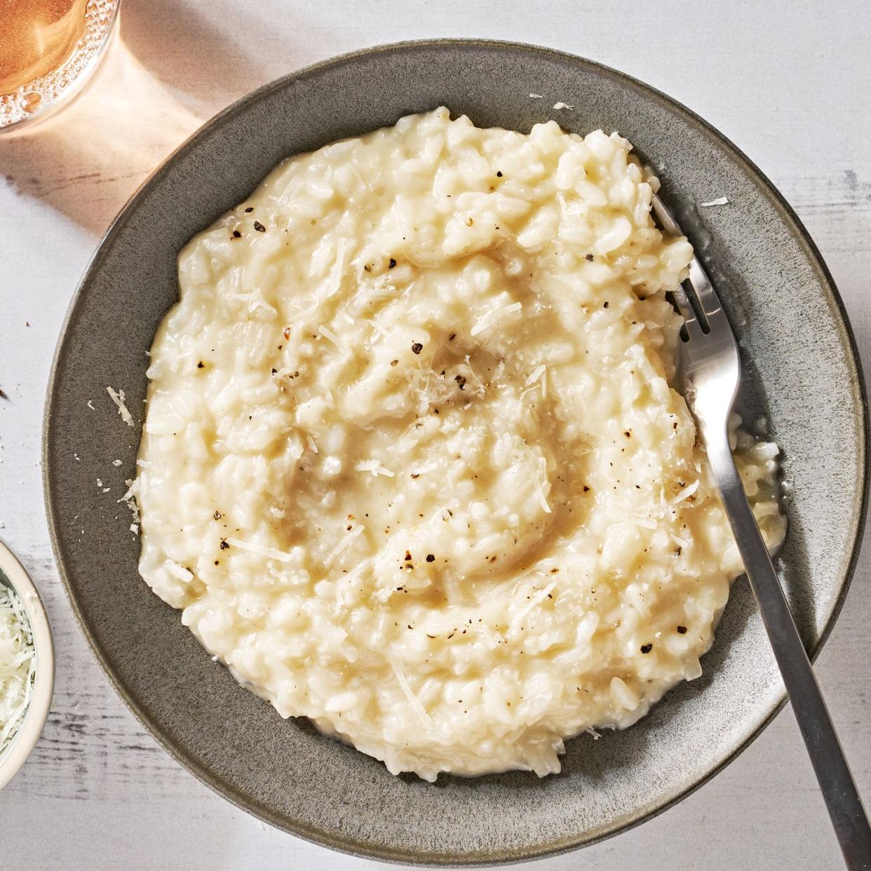 risotto on a plate topped with black pepper and parmesan