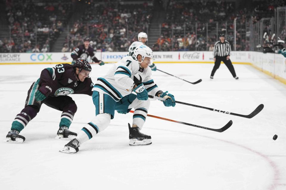 San Jose Sharks' Nico Sturm (7) is defended by Anaheim Ducks' Jakob Silfverberg (33) during the first period of an NHL hockey game Sunday, Nov. 12, 2023, in Anaheim, Calif. (AP Photo/Jae C. Hong)