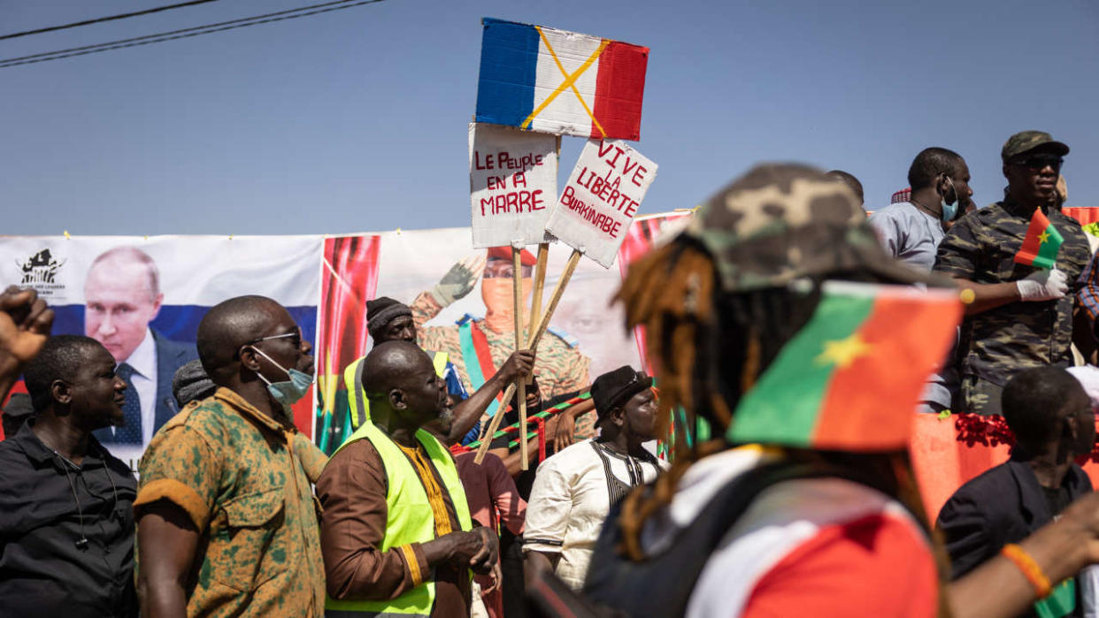 A demonstrator holds placards during a protest to support the Burkina Faso President Captain Ibrahim Traore and to demand the departure of France's ambassador and military forces, in Ouagadougou, on January 20, 2023. (Photo by OLYMPIA DE MAISMONT / AFP)