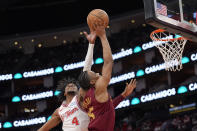Cleveland Cavaliers' Isaac Okoro, right, has his shot blocked by Houston Rockets' Jalen Green (4) during the first half of an NBA basketball game Saturday, March 16, 2024, in Houston. (AP Photo/David J. Phillip)