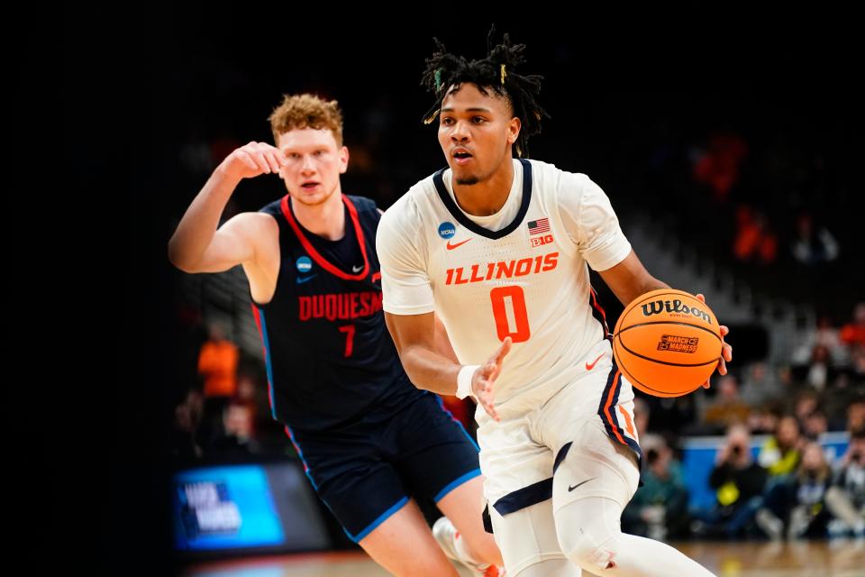 Illinois guard Terrence Shannon Jr. dribbles past Duquesne forward Jake Necas during the second round of the men's NCAA Tournament.