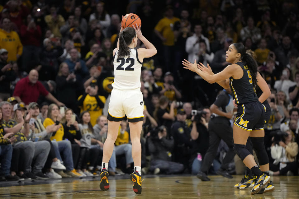 Iowa guard Caitlin Clark (22) shoots against Michigan during the first half of an NCAA college basketball game, Thursday, Feb. 15, 2024, in Iowa City, Iowa. With the basket, Clark broke the NCAA women's career scoring record. (AP Photo/Matthew Putney)