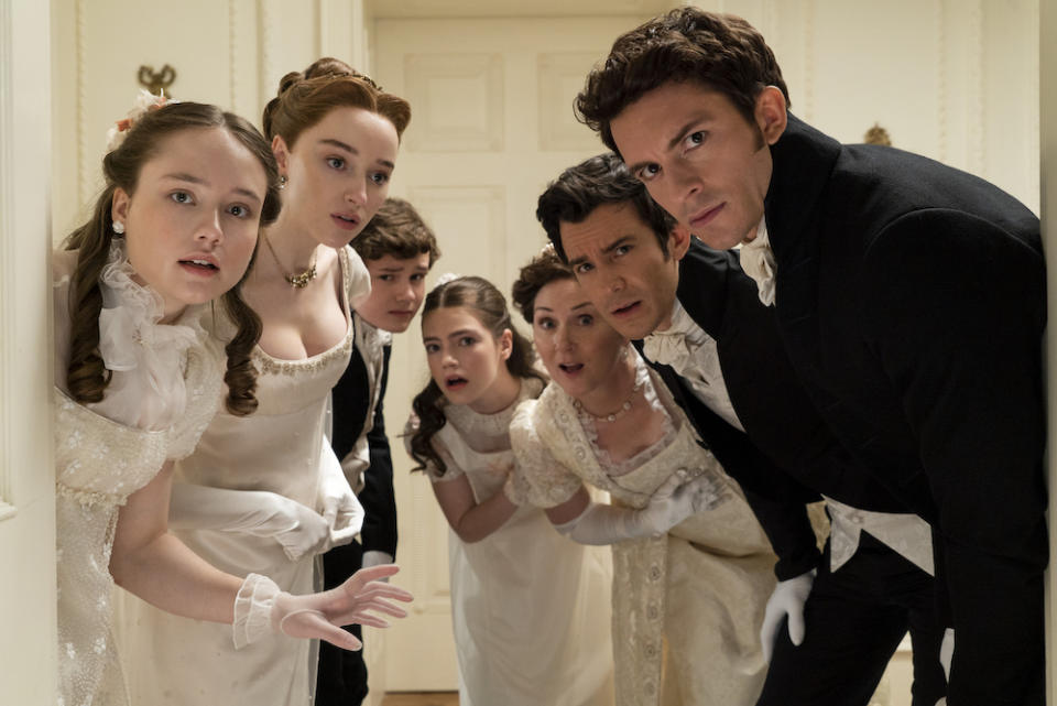 Bridgerton. (L to R) Ruby Stokes as Francesca Bridgerton, Phoebe Dyvenor as Daphne Basset, Will Tilston as Gregory Bridgerton, Florence Emilia Hunt as Hyacinth Bridgerton, Ruth Gemmell as Lady Violet Bridgerton, Luke Thompson as Benedict Bridgerton, Jonathan Bailey as Anthony Bridgerton in episode 201 of Bridgerton. Cr. Liam Daniel/Netflix © 2022