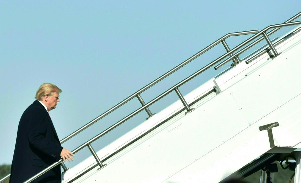 <p>President Donald Trump boards Airforce One at Jackson-Medgar Wiley Evers International Airport in Jackson, Miss., on Dec. 9, 2017. (Photo: Nicholas Kamm/AFP/Getty Images) </p>