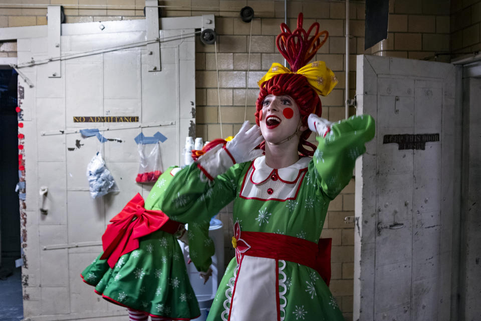 In this Monday, Nov. 25, 2019 photo, Rockette Sydney Mesher prepares backstage in her Rag Doll costume before going back onstage during a performance at Radio City Music Hall in New York. Mesher, who was born without a left hand due to the rare congenital condition symbrachydactyly, is the first person with a visible disability ever hired by New York's famed Radio City Rockettes. (AP Photo/Craig Ruttle)