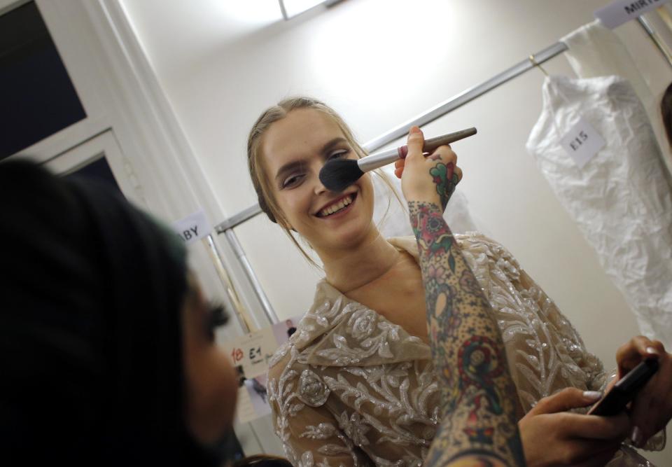 A model is made up backstage prior to the Valentino Spring Summer 2013 Haute Couture fashion collection, presented in Paris, Wednesday, Jan.23, 2013. (AP Photo/Christophe Ena)