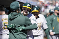 Oakland Athletics' Zack Gelof is greeted in the dugout after his three-run home run during the second inning of a baseball game against the Detroit Tigers, Sunday, April 7, 2024, in Detroit. (AP Photo/Carlos Osorio)