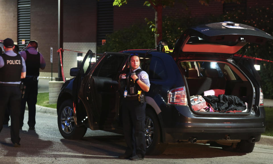 Police guard an SUV wherein a 3-year-old boy was fatally shot while riding in the vehicle with his father, outside West Suburban Medical Center Saturday, June 20, 2020, in Oak Park, in Chicago. The boy was struck in the Austin neighborhood, and his father drove to the hospital, where he was pronounced dead. Multiple people, including several children, were killed as more than 100 people were shot in a wave of gunfire in Chicago over the Father’s Day weekend that produced the city’s highest number of shooting victims in a single weekend this year. (John J. Kim/Chicago Tribune via AP)
