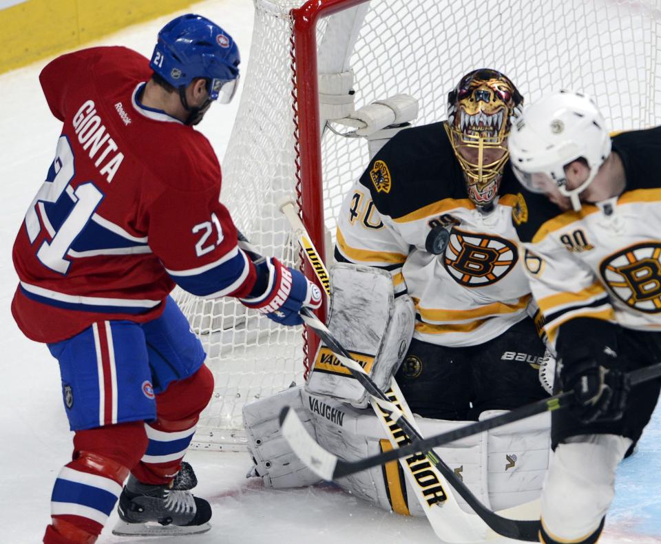 Boston Bruins goalie Tuukka Rask (40) makes the save on Montreal Canadiens right wing Brian Gionta (21) during the first period in Game 4 in the second round of the NHL Stanley Cup playoffs Thursday, May 8, 2014, in Montreal. (AP Photo/The Canadian Press, Ryan Remiorz)