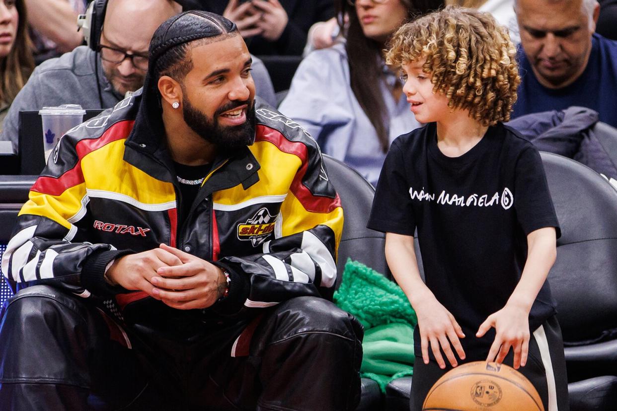 Drake plays with his son Adonis during the second half of the NBA game between the Toronto Raptors and the LA Clippers