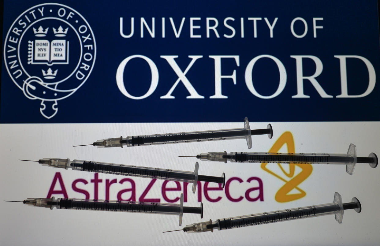 An illustrative photo showing a medical syringe seen in front of Pfizer-BionTech, Moderna and AstraZeneca-University of Oxford logos displayed on screens in the background on Christmas Eve. On Thursday, December 24, 2020, in Dublin, Ireland. (Photo illustration by Artur Widak/NurPhoto via Getty Images)