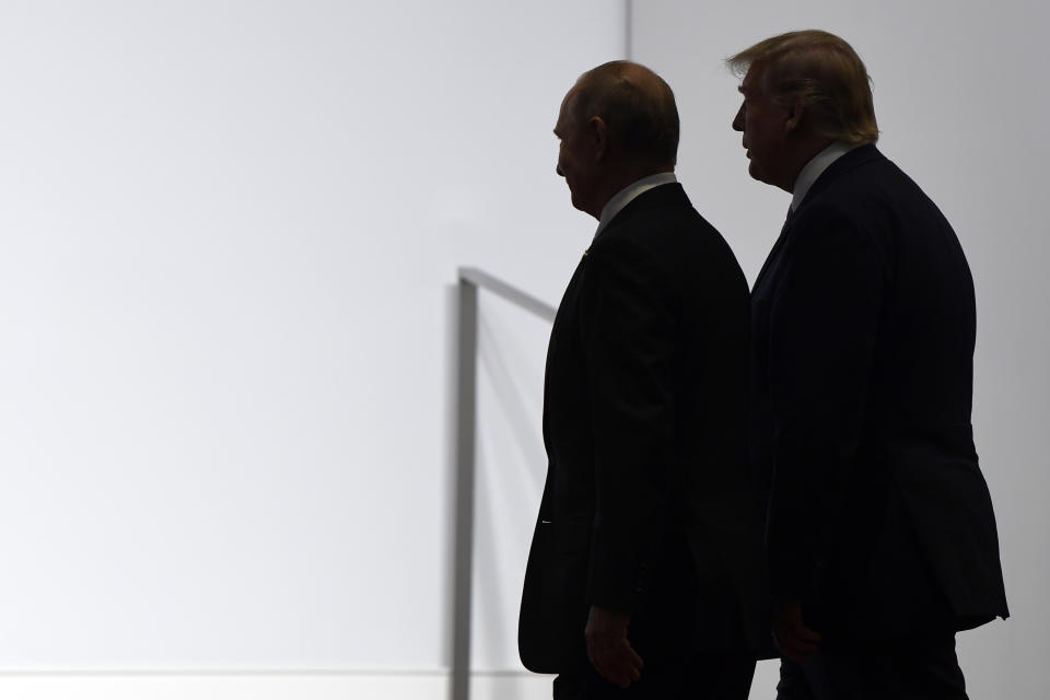 FILE - In this June 28, 2019, file photo President Donald Trump and Russian President Vladimir Putin walk to participate in a group photo at the G20 summit in Osaka, Japan. For the past three years, the administration has careered between President Donald Trump's attempts to curry favor and friendship with Vladimir Putin and longstanding deep-seated concerns about Putin's intentions. (AP Photo/Susan Walsh, File)