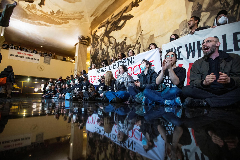 Demonstrators protest inside the Rockefeller Center asking for a ceasefire in the ongoing conflict between Israel and the Palestinian Islamist group Hamas, as U.S. President Joe Biden attends an interview in midtown Manhattan, in New York, U.S. February 26, 2024. REUTERS/Eduardo Munoz