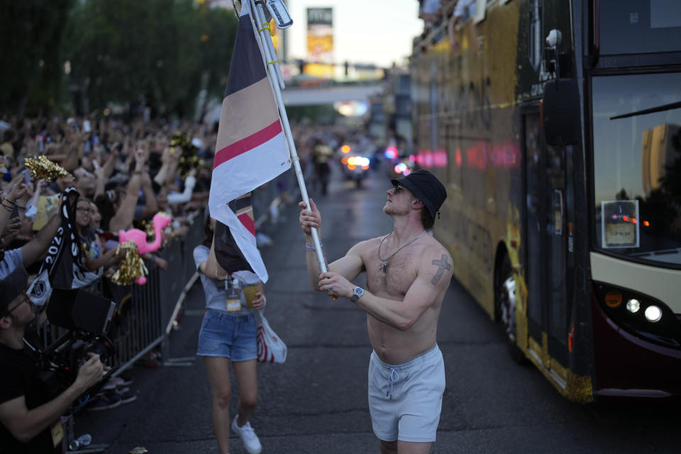 Vegas Golden Knights center Jack Eichel carries a flag during a parade along the Las Vegas Strip for the NHL hockey champions Saturday, June 17, 2023, in Las Vegas. (AP Photo/John Locher)