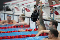 Caeleb Dressel, of United States, celebrates after winning the gold medal in the men's 100-meter butterfly final at the 2020 Summer Olympics, Saturday, July 31, 2021, in Tokyo, Japan. (AP Photo/David Goldman)