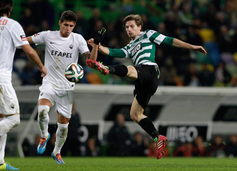 Sporting's Adrien Silva, right, goes for the ball during their Portuguese league soccer match with Academica, Sunday, Feb. 2 2014, at Sporting's Alvalade stadium in Lisbon. (AP Photo/Armando Franca)