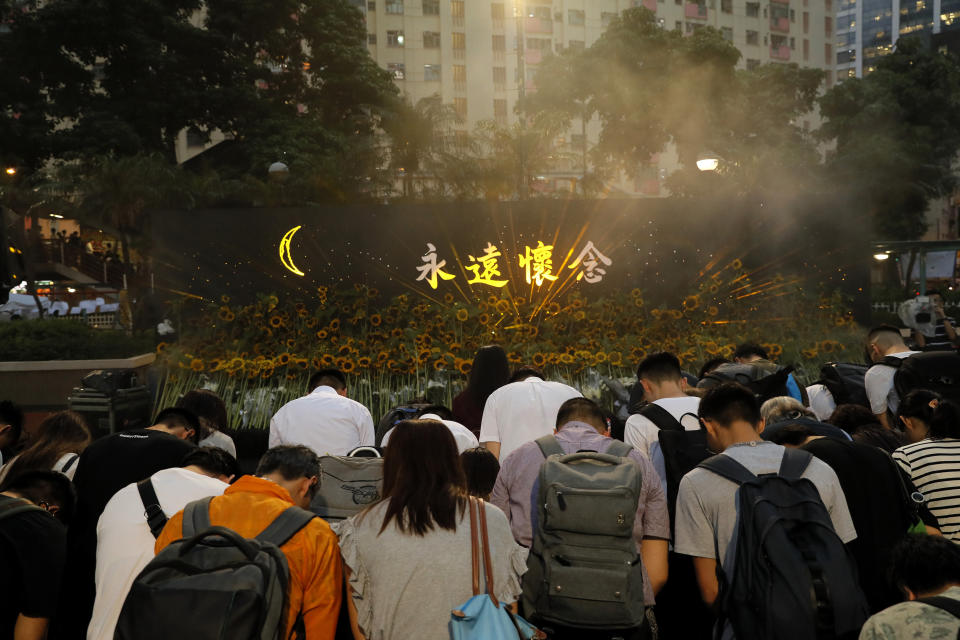 Attendees take part in a public memorial for Marco Leung, the 35-year-old man who fell to his death weeks ago after hanging a protest banner against an extradition bill, in Hong Kong, Thursday, July 11, 2019. The parents of Leung urged young people to stay alive to continue their struggle. (AP Photo/Kin Cheung)