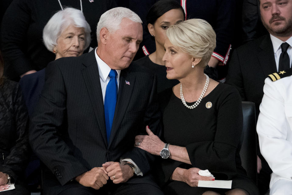 Vice President Mike Pence confers with Cindy McCain.