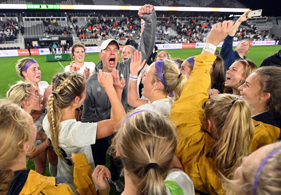 Copley girls soccer coach Wally Senk celebrates with his girls after winning the OHSAA Division II girls state soccer championship for the first time in school history at Lower.com Field,  Friday, Nov. 11, 2022, in Columbus, Ohio.