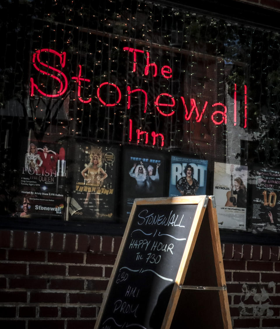 In this Monday, June 3, 2019 photo, the current Stonewall Inn is open for afternoon business in New York. Fifty years ago, the Stonewall Inn was an underground gay bar where a police raid sparked a rebellion that fueled the modern LGBTQ rights movement. Today, it’s still a bar, but a highly visible one. It’s a landmark, and the patrons flocking in this week to honor the Stonewall riots’ 50th anniversary include a gay police officers’ group. (AP Photo/Bebeto Matthews)