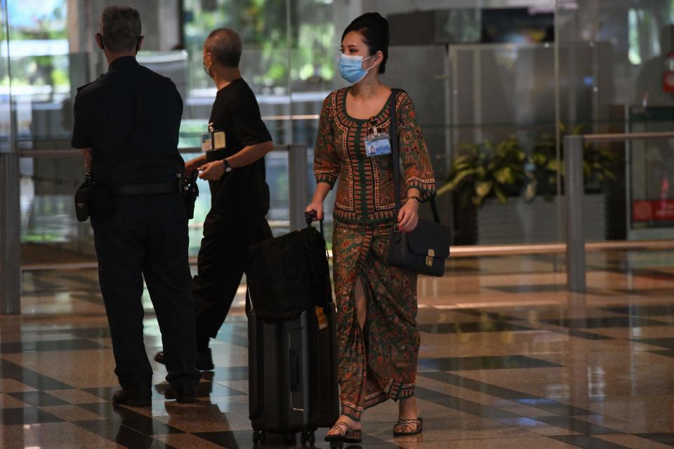 A Singapore Airlines stewardess returns from a flight at Changi International Airport terminal in Singapore on June 8, 2020, as Singapore prepares to reopen its borders after shutting them to curb the spread of the COVID-19 novel coronavirus. (Photo by Roslan RAHMAN / AFP) (Photo by ROSLAN RAHMAN/AFP via Getty Images)